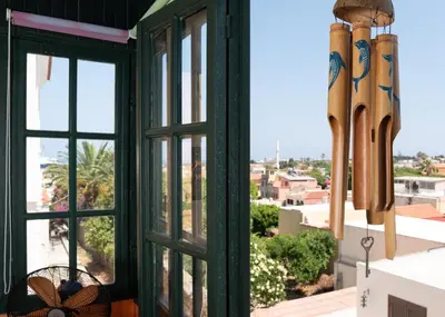 a room with a window with baseball bats at Labyrinthos Arts Guest House in Rhodes Town
