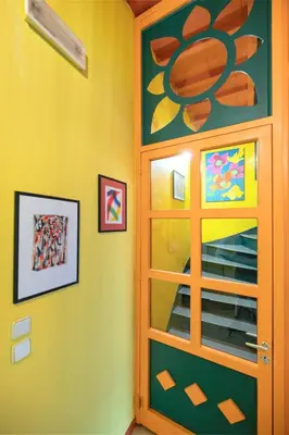 a door with a painting on it in a room at Labyrinthos Arts Guest House in Rhodes Town
