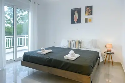 a bedroom with a bed with two towels on it at Katerina & Stefanos Family apartments in Archangelos