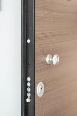 a close up of a wooden door with silver knobs at Katerina & Stefanos Family apartments in Archangelos