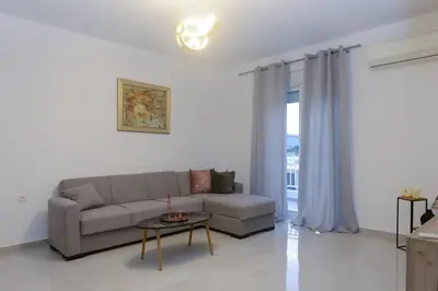 a living room with a couch and a table at Katerina & Stefanos Family apartments in Archangelos