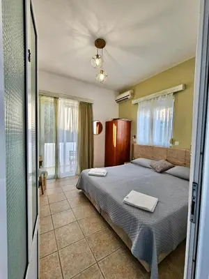 a bedroom with a large bed in a room at Lindos Tsambika Studios in Líndos
