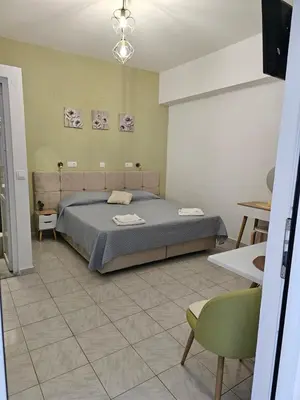 a bedroom with a bed and a tv in it at Lindos Tsambika Studios in Líndos