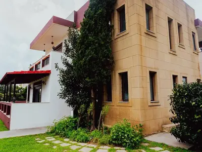 a building with a tree in front of it at Papa’s house in Kalithies