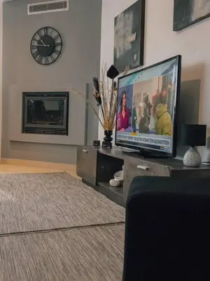 a living room with a large flat screen tv at Papa’s house in Kalithies