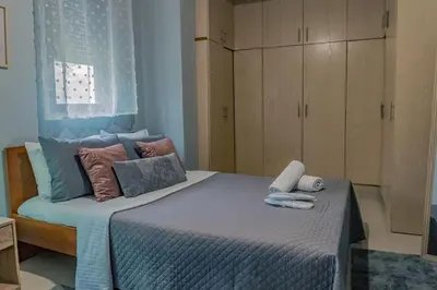 a bedroom with a large bed with towels on it at Papa’s house in Kalithies