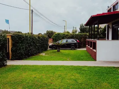 a car parked in a driveway next to a house at Papa’s house in Kalithies