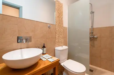 a bathroom with a white sink and a toilet at Casa Antica in Rhodes Town