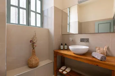 a bathroom with a sink and a mirror at Casa Antica in Rhodes Town