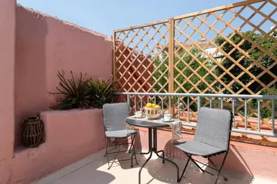two chairs and a table on a balcony at Casa Antica in Rhodes Town