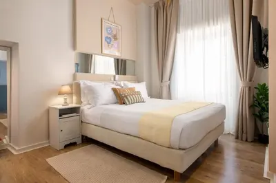 a bedroom with a large bed and a window at Casa Antica in Rhodes Town
