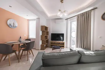 a living room with a couch and a table at Archangelos SKY Garden Apartment in Archangelos