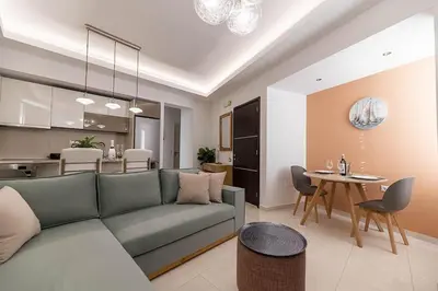 a living room with a couch and a table at Archangelos SKY Garden Apartment in Archangelos