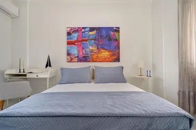 a bedroom with a bed and a painting on the wall at Gia's Luxury Residence in Asgourou
