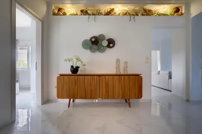 a living room with a wooden cabinet on a wall at Gia's Luxury Residence in Asgourou