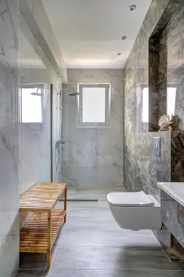 a bathroom with a tub and a toilet and a sink at Gia's Luxury Residence in Asgourou