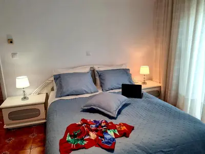 a bedroom with a bed with a laptop on it at City Center Luxury Spacious apt A&M in Rhodes Town