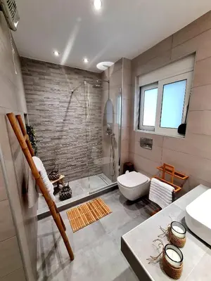 a bathroom with a shower and a toilet and a sink at City Center Luxury Spacious apt A&M in Rhodes Town