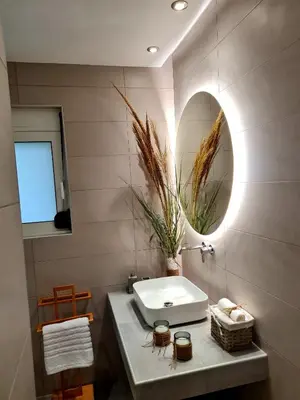 a bathroom with a sink and a mirror at City Center Luxury Spacious apt A&M in Rhodes Town