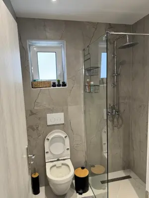 a bathroom with a toilet and a shower at Cozy City Center Apartment in Rhodes Town