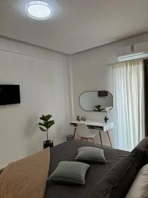 a bedroom with a large bed and a desk at Cozy City Center Apartment in Rhodes Town