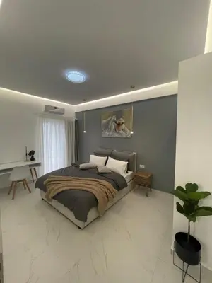 a bedroom with a large bed and a desk at Cozy City Center Apartment in Rhodes Town