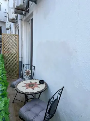 a patio with a table and chairs on a balcony at Cozy City Center Apartment in Rhodes Town