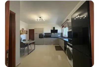 a kitchen with a table and a dining room at Sea view Holiday House Ialisos in Triánta