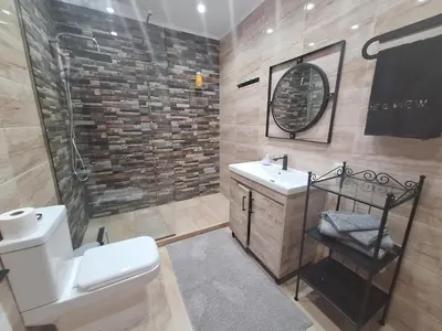 a bathroom with a toilet and a sink and a shower at Sea view Holiday House Ialisos in Triánta