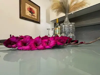 a bunch of pink flowers sitting on a table at Sea view Holiday House Ialisos in Triánta