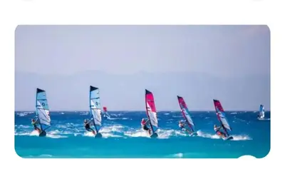 a group of people windsurfing in the ocean at Sea view Holiday House Ialisos in Triánta