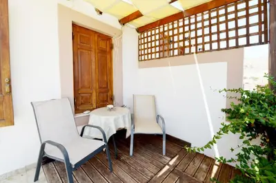 two chairs and a table on a porch at Villa Magdalini in Halki