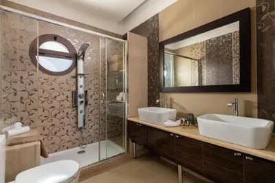 a bathroom with two sinks and a shower at Physis Luxury Villa in Archangelos