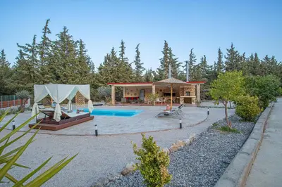 a home with a swimming pool and a house at Physis Luxury Villa in Archangelos