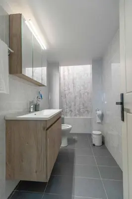 a bathroom with a sink and a toilet at Grande Terra in Kiotari