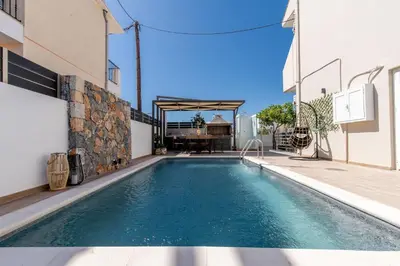 a swimming pool in the middle of a house at Grande Terra in Kiotari