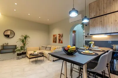 a living room with a table with a bowl of fruit on it at Grande Terra in Kiotari