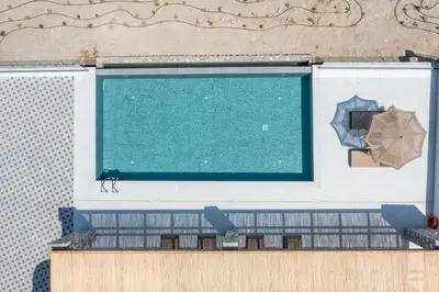 a swimming pool on the side of a building at Athoros Luxury Villas in Afantou