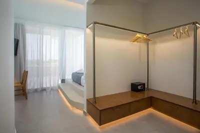 a room with a mirror and a bed and a bedroom at Athoros Luxury Villas in Afantou