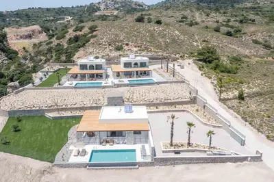 an aerial view of a house with a mountain at Athoros Luxury Villas in Afantou