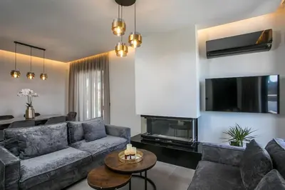 a living room with a couch and a fireplace at Villa Seranti in Asgourou
