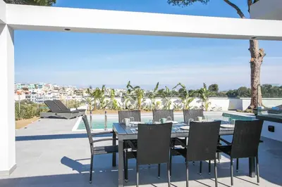 a table and chairs on a patio with a view at Villa Seranti in Asgourou
