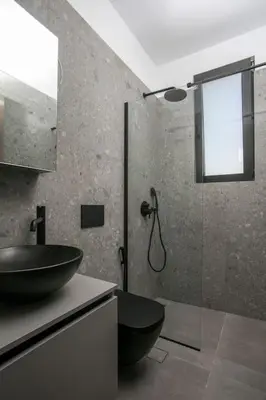 a bathroom with a sink and a glass shower at Villa Seranti in Asgourou