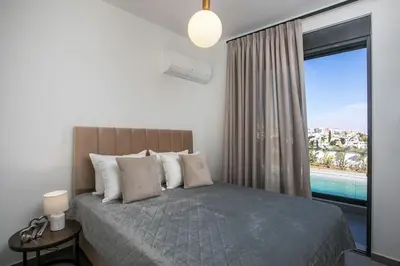 a bedroom with a bed with a view of the ocean at Villa Seranti in Asgourou