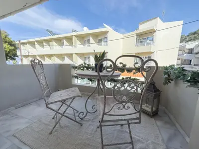 a pair of chairs and a table on a balcony at Ixia home in Ixia