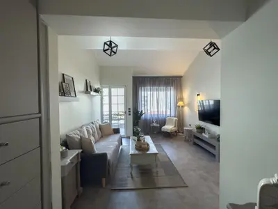a living room with a couch and a table at Ixia home in Ixia