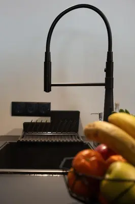 a kitchen counter with a bowl of fruit and a lamp at Ixia home in Ixia