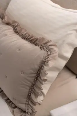 a white pillow sitting on top of a bed at Ixia home in Ixia