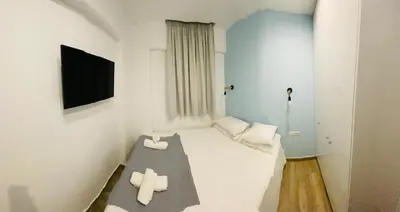 a small room with a bed with two white towels at Block66 in Rhodes Town