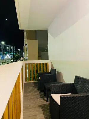 a row of chairs and tables on a balcony at night at Block66 in Rhodes Town